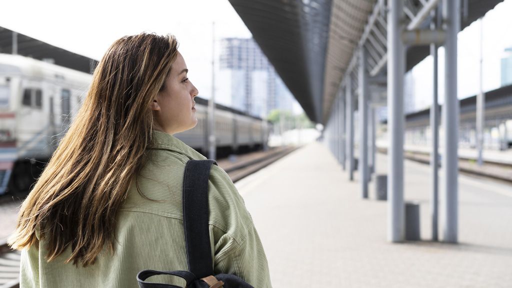 Kobieta stojąca na peronie - PKP opóźnienia pociągów