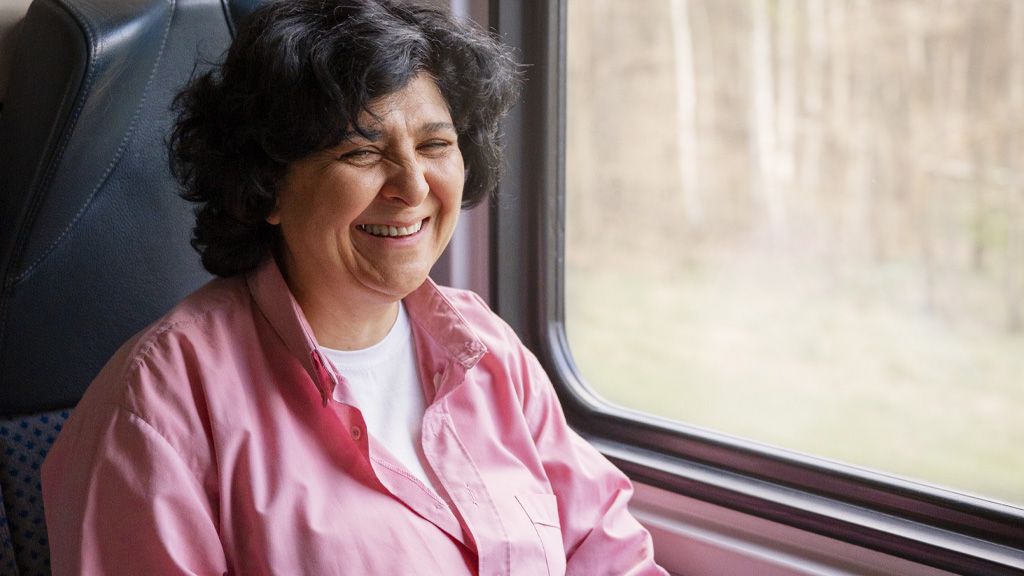 Starsza pani przy oknie w pociągu
